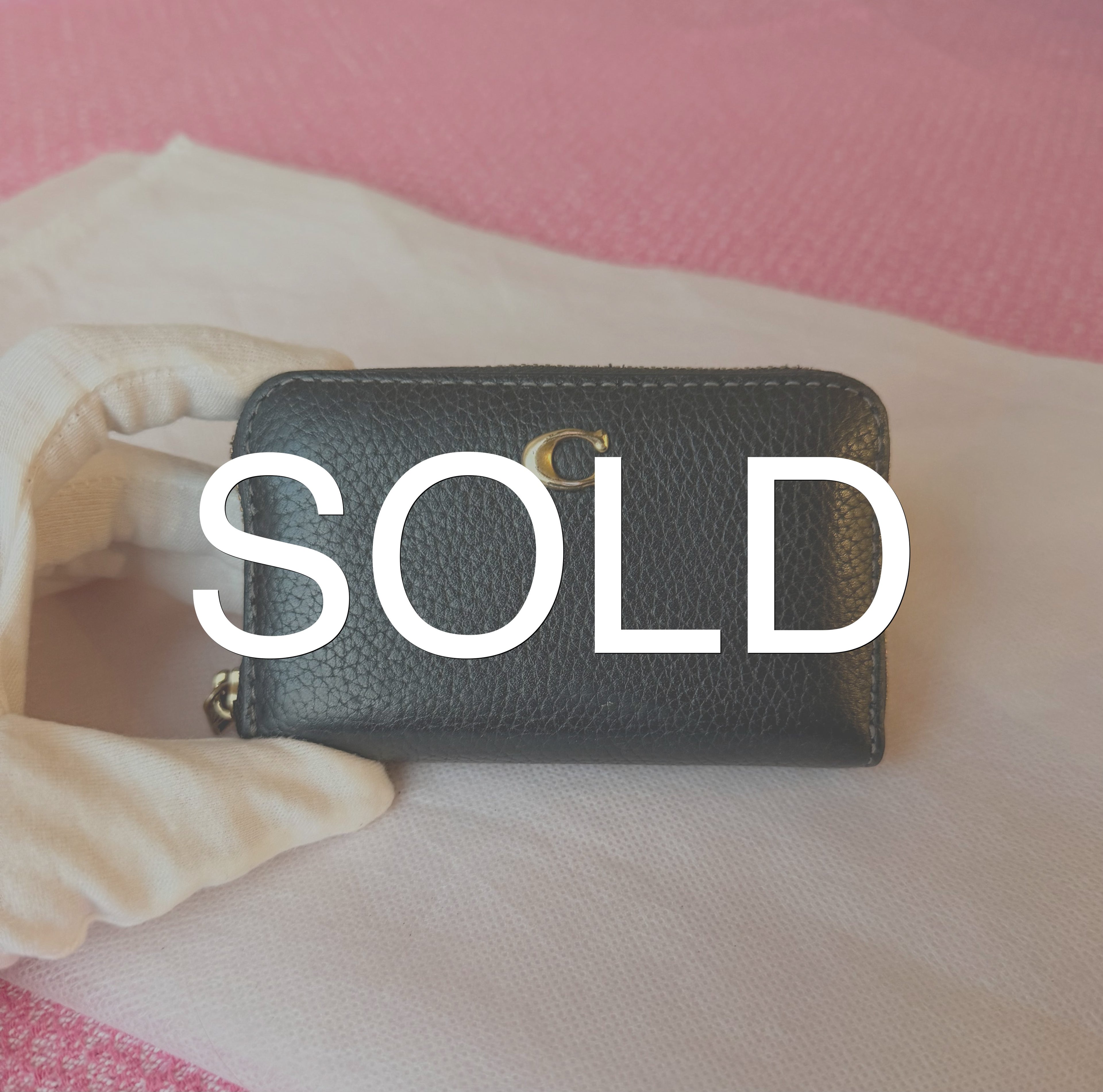 Coach small zip-around wallet black leather — front view