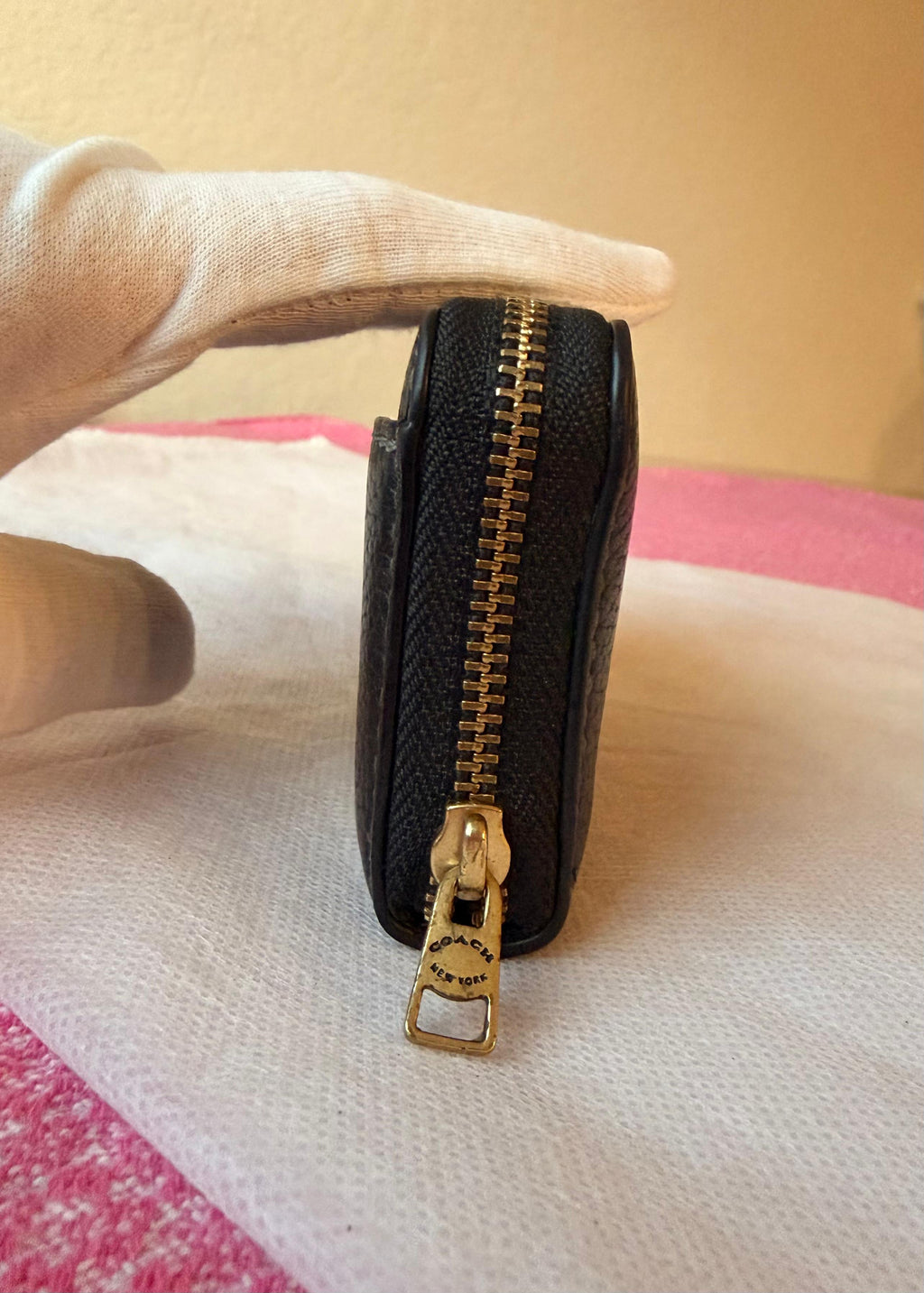 Coach small zip-around wallet black leather — hardware detail