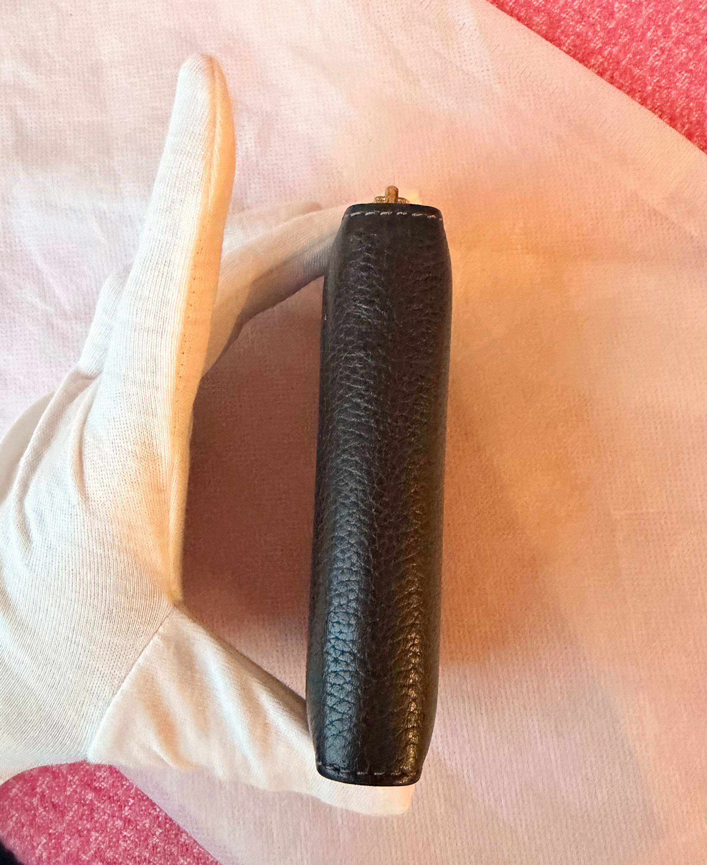 Coach small zip-around wallet black leather — strap detail