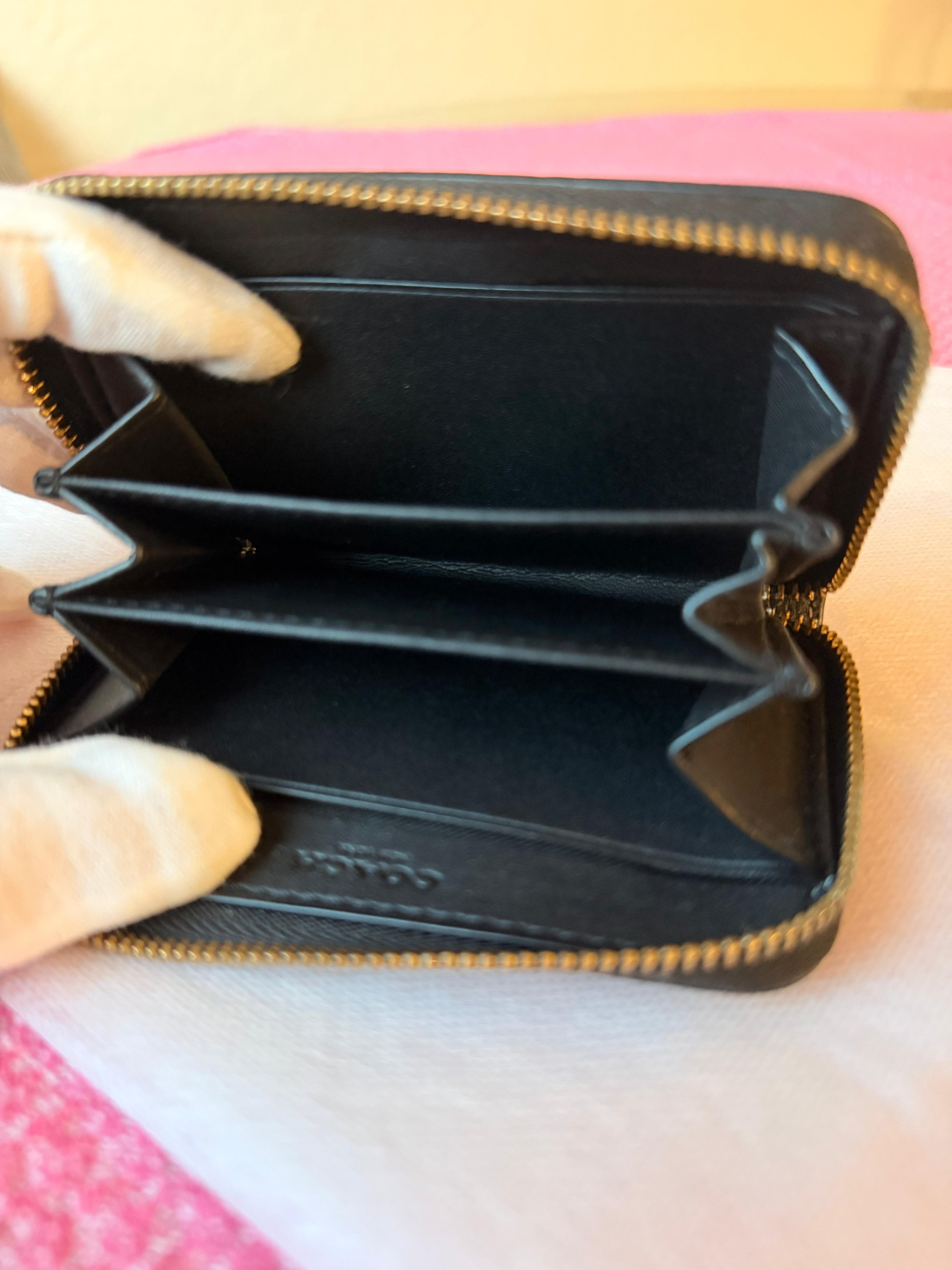 Coach small zip-around wallet black leather — angle view