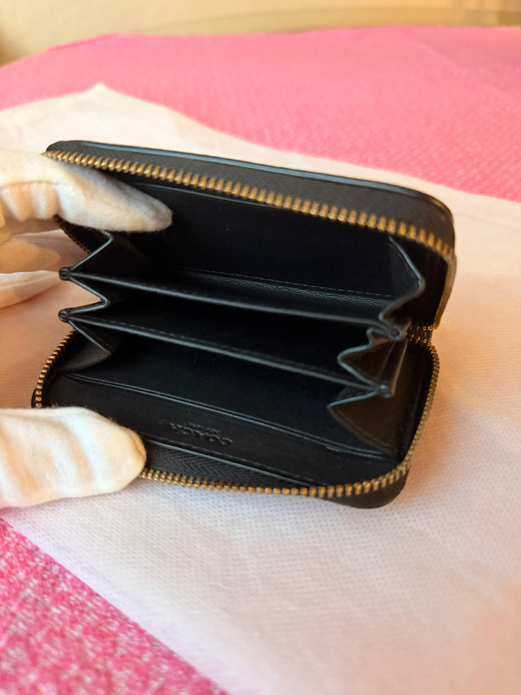 Coach small zip-around wallet black leather — bottom view